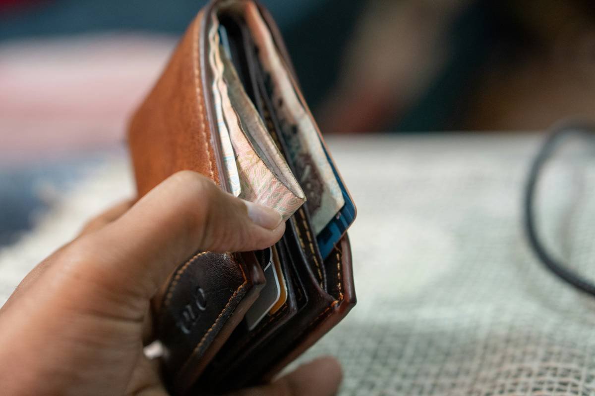 Man frantically searching through backpack after experiencing travel document loss at airport security